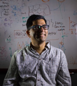 Dr. Chakra Chennubhotla standing in front of a white board with equations written on it